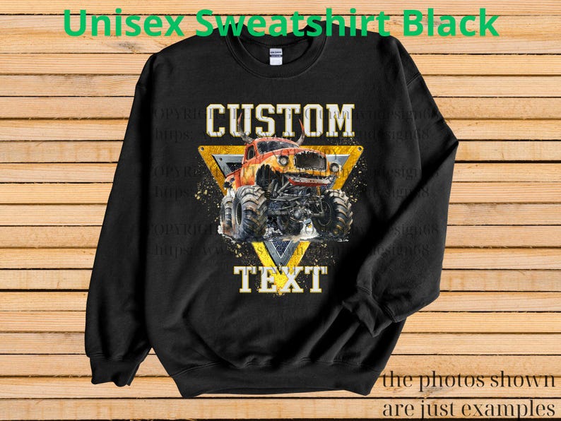 May include: Black unisex sweatshirt with a graphic of a monster truck inside a yellow triangle. The words "CUSTOM" and "TEXT" are above and below the truck. The sweatshirt has long sleeves and a crew neck.