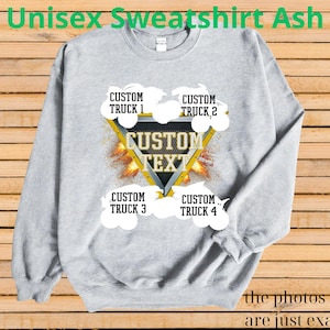May include: Ash gray unisex sweatshirt with a custom text design. The design features a yellow triangle with the words "CUSTOM TEXT" and four areas for custom truck names. The text "the photos shown are just examples" is at the bottom.