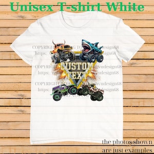 May include: White unisex t-shirt featuring a graphic of four monster trucks in various colors. The design includes the text "CUSTOM TEXT" in a yellow and black emblem. The shirt also has the text "Unisex T-shirt White".