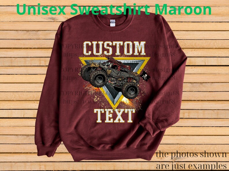 May include: Maroon unisex sweatshirt featuring a custom design. The design includes a monster truck graphic within a yellow triangle, with the words "CUSTOM" and "TEXT" in white. The sweatshirt has long sleeves and a crew neck.