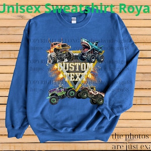 May include: Royal blue unisex sweatshirt featuring a graphic of monster trucks. The design includes a shield with the text "CUSTOM TEXT" and images of monster trucks. The text "Unisex Sweatshirt Royal" is at the top.