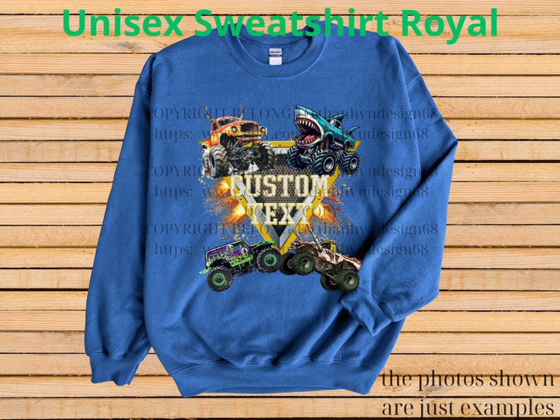 May include: Royal blue unisex sweatshirt featuring a graphic of monster trucks. The design includes a shield with the text "CUSTOM TEXT" and images of monster trucks. The text "Unisex Sweatshirt Royal" is at the top.