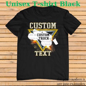 May include: Black unisex t-shirt with a custom design. The design features the word "CUSTOM" above a yellow triangle with a truck graphic and the words "CUSTOM TRUCK TEXT". The shirt also has the text "the photos shown are just examples".