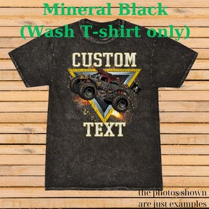 May include: Mineral black t-shirt with a custom design. The design features a monster truck illustration inside a yellow triangle, with the word "CUSTOM" above and "TEXT" below. The shirt has a textured appearance.