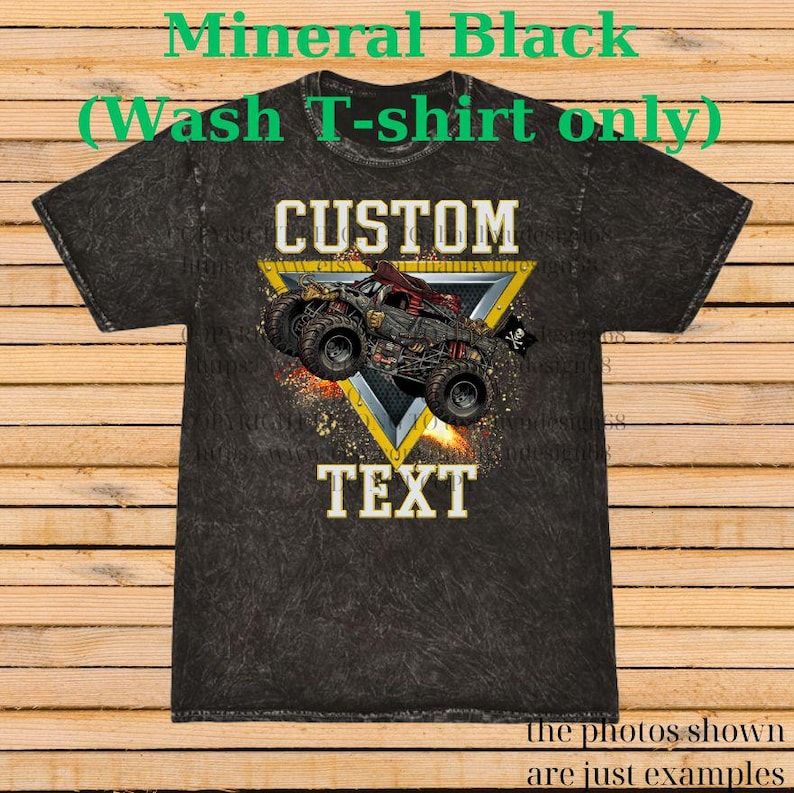 May include: Mineral black t-shirt with a custom design. The design features a monster truck illustration inside a yellow triangle, with the word "CUSTOM" above and "TEXT" below. The shirt has a textured appearance.