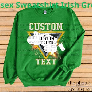 May include: A green unisex sweatshirt with a custom truck design. The design includes a yellow triangle with the words "CUSTOM TRUCK TEXT" in white. The sweatshirt has long sleeves and a crew neck.