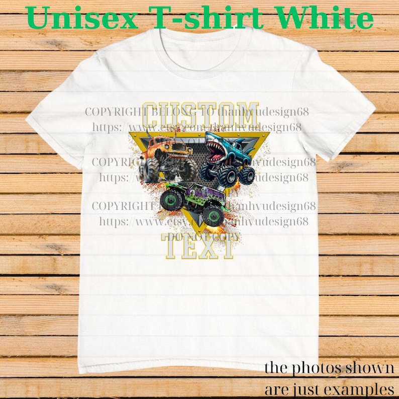 May include: White unisex t-shirt featuring a graphic of three monster trucks in orange, blue, and green, set against a yellow triangle. The shirt has the text "CUSTOM TEXT" and "Unisex T-shirt White" in green.