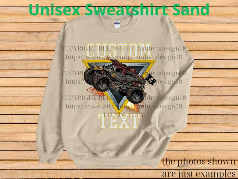 May include: Sand-colored unisex sweatshirt featuring a graphic of a monster truck with a skull and crossbones flag. The design is set within a yellow triangle with the words "CUSTOM TEXT" and "DO NOT COPY". The sweatshirt has the text "Unisex Sweatshirt Sand" at the top.