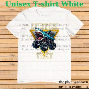 May include: White unisex t-shirt featuring a blue monster truck with a shark head design. The shark has an open mouth with visible teeth. The shirt has the text "CUSTOM TEXT" in a yellow triangle.