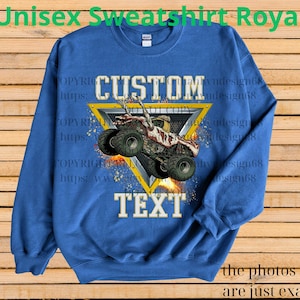 May include: Royal blue unisex sweatshirt with a custom design. The design features a monster truck inside a yellow triangle, with the words "CUSTOM" and "TEXT". The sweatshirt has long sleeves and a crew neck.