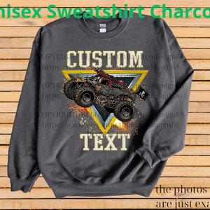 May include: Charcoal gray unisex sweatshirt featuring a custom design. The design includes a monster truck graphic within a yellow triangle, with the words "CUSTOM TEXT" in white. The sweatshirt has a crew neck and long sleeves.