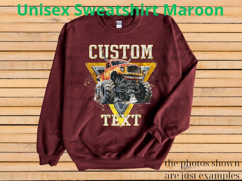 May include: Maroon unisex sweatshirt featuring a custom design of an orange monster truck inside a yellow triangle. The text "CUSTOM" and "TEXT" are displayed above and below the truck. The phrase "the photos shown are just examples" is at the bottom.