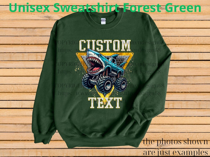 May include: Forest green unisex sweatshirt with a graphic of a shark-themed monster truck. The design includes the words "CUSTOM" and "TEXT" in a yellow triangle. The text "Unisex Sweatshirt Forest Green" is at the top.