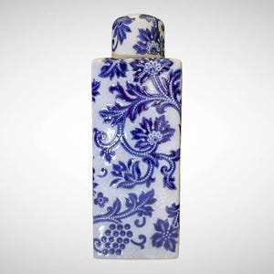 May include: A rectangular ceramic container with a matching lid, featuring a white background and intricate blue floral patterns. The design includes stylized flowers, leaves, and vines, creating a classic, decorative aesthetic.