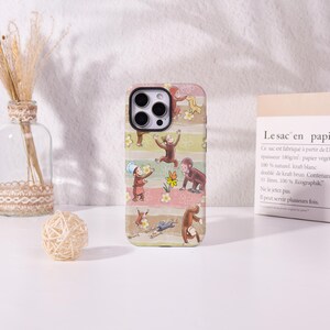 May include: A phone case with a fun monkey pattern. The design includes several monkeys in different poses, set against a striped background with flowers. The case is designed for a smartphone.