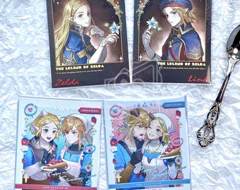 May include: Four The Legend of Zelda character art cards. Two cards feature Zelda and Link, with the text "The Legend of Zelda" and character names. The other two cards show Link and Zelda together, with text "Strawberry Cream" and "Poppy Strawberries".