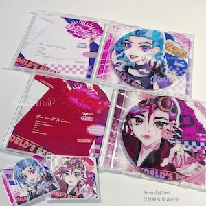 May include: Two clear plastic CD cases featuring anime-style character art of Jinx and Vi. The Jinx case includes a blue-haired character, while the Vi case features a pink-haired character with goggles. Both include tracklists and the text BANG!