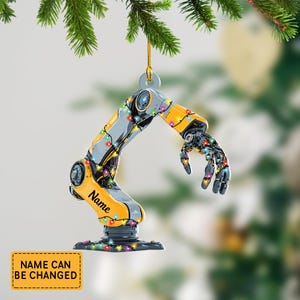 May include: A yellow and gray robotic arm Christmas ornament with a string of colorful lights. The ornament has the word "Name" on it and the text "NAME CAN BE CHANGED" on a yellow rectangle.