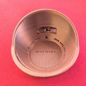May include: A close-up of a 3D printed, gold-colored, bowl-shaped object with the text "3D FUNXION" printed on the inside.