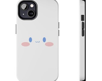 May include: White phone case with a cute cartoon face with blue eyes and pink cheeks. The case has a black camera cutout and a black border.