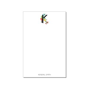 May include: White notepad with a floral design and the letter K in black. The name Kendall Smith is printed at the bottom of the notepad.