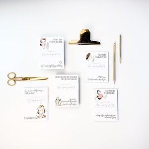 May include: Five white cards with black and gray text and illustrations of women. The cards have quotes about getting ready, such as "Sometimes only mascara can fix a rough day." and "I can't fix your life, but I can fix your hair."