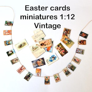 Puede incluir: Una guirnalda de tarjetas de Pascua vintage, cada una con una imagen diferente, cuelga de una línea de cuerda. Las tarjetas son en miniatura, a escala 1:12. Las tarjetas son de varios colores y presentan imágenes de conejos, pollitos y otros símbolos de Pascua.