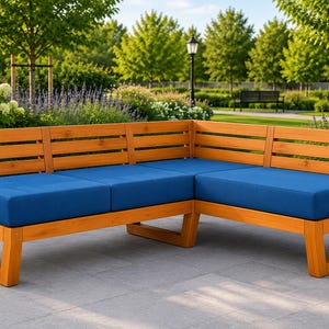 May include: An L-shaped outdoor sectional sofa constructed from light brown wood with horizontal slat backrests. The seating features thick, solid blue cushions that cover the entire length of the bench sections, providing a clean, uniform look.