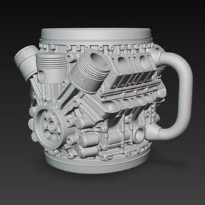 Puede incluir: Una taza de cerámica gris con forma de motor V8. La taza presenta componentes detallados del motor, incluidos pistones, una polea y un asa curva. Un artículo de novedad único para los entusiastas de los automóviles.