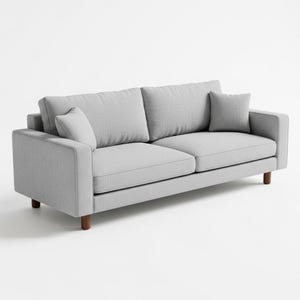 Puede incluir: Un sofá gris claro de dos plazas con dos cojines de respaldo y dos cojines decorativos más pequeños. El sofá tiene una forma cuadrada con una tela texturizada y se apoya en cuatro patas de madera. El diseño es moderno y minimalista.