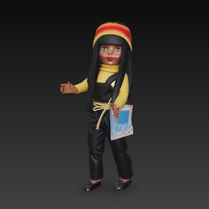 May include: A vintage doll with black hair, wearing a yellow turtleneck, black overalls, and a colourful hat. The doll holds a small, patterned item. The doll's outfit is accented with a gold-coloured rope.