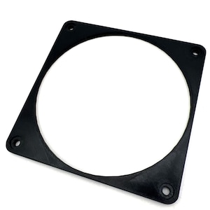 May include: A black square fan grill with a circular opening in the center. The grill has four mounting holes, one in each corner. The fan grill is made of a matte black material.