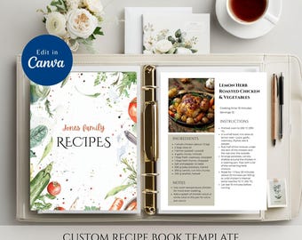 May include: A custom recipe book template with a light-colored leather binder. The book features a floral design and the text "Jones family RECIPES". A recipe for Lemon Herb Roasted Chicken & Vegetables is displayed. The text "Edit in Canva" is visible.