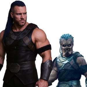 May include: A muscular person in a black leather-like outfit with a brown belt and armbands, and blue hair. Beside them is a Predator character with a gray face, blue hair, and armor.