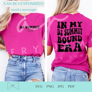 May include: A magenta t-shirt with the text "D2 SUMMIT +2026" on the front and "IN MY D2 SUMMIT BOUND ERA" on the back. The shirt is paired with blue jeans. The image also includes the text "CAN BE CUSTOMIZED send a message".