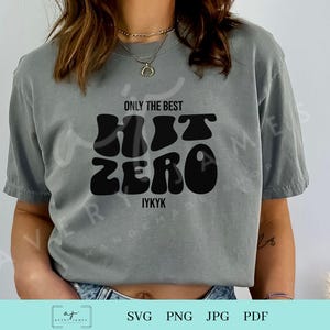 May include: A gray t-shirt with the text "Only the best Hit Zero IYKYK" in black retro-style lettering.