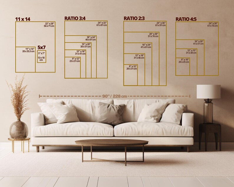 May include: A beige wall displays framed art size examples, including 11x14 inches, 5x7 inches, and others with ratios 3:4, 2:3, and 4:5. A white sofa with pillows, a coffee table, and a lamp are in front of the wall. The text on the wall includes measurements in inches and centimeters.