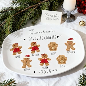 May include: A white oval serving platter with the text "Grandma's Favorite Cookies" and gingerbread cookie designs. The platter includes names and the year 2025. A small card reads "Found the Gin list."