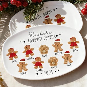 May include: Two white oval platters with a festive design. The platters feature gingerbread people, paw prints, and the text "Rachel's Favorite Cookies" and names. The design includes the year 2025. Festive holiday decor.