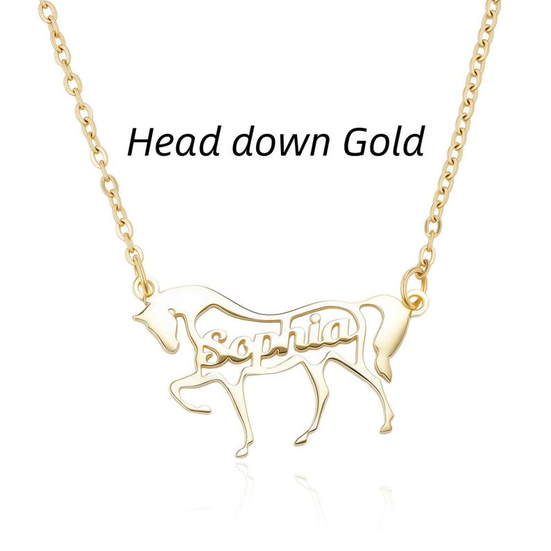 May include: A gold-toned necklace featuring a pendant shaped like a horse with its head down. The name Sophia is cut out from the center of the horse's body. The text Head down Gold is visible above the pendant, which hangs from a delicate chain.