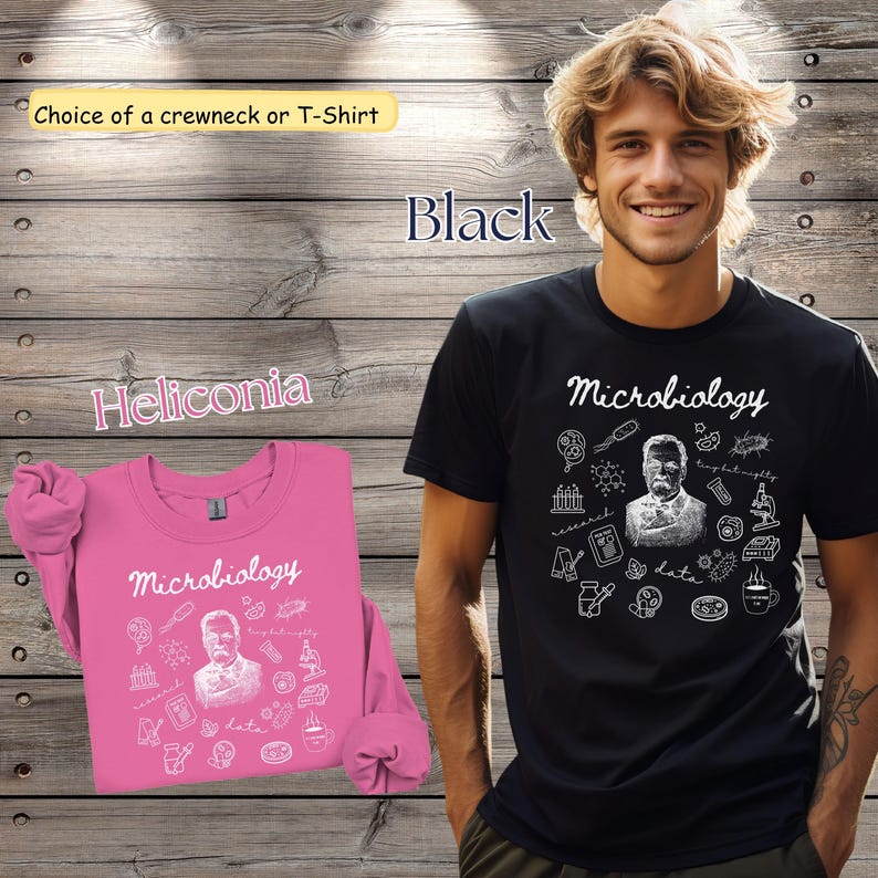 May include: A black t-shirt and a pink crewneck sweatshirt, both featuring the word "Microbiology" in script, along with a portrait and scientific illustrations. The image also includes the text "Choice of a crewneck or T-Shirt" and "Heliconia".