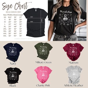 May include: A size chart and a variety of t-shirts in different colors are displayed. The shirts feature the word "Microbiology" and a graphic. Colors include navy, military green, maroon, black, charity pink, and athletic heather.