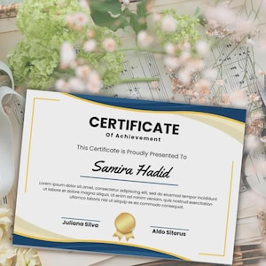 May include: A certificate of achievement with a blue and gold border. The certificate reads "CERTIFICATE Of Achievement" and is presented to "Samira Hadid". Includes the names Juliana Silva and Aldo Sitorus.