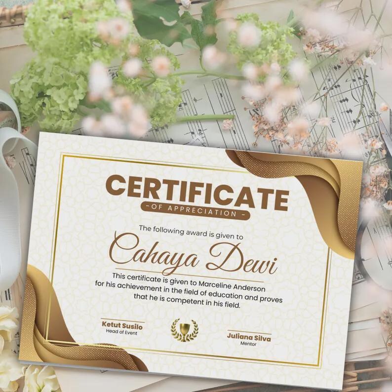 May include: A certificate of appreciation with a gold and brown design. The text reads "CERTIFICATE OF APPRECIATION" and "Cahaya Dewi". The certificate is given to Marceline Anderson for achievement in education.