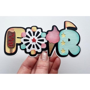 May include: A paper craft word "FAIR" with a carnival theme. The letters are decorated with images of a hot dog, a Ferris wheel, cotton candy, and a tent.