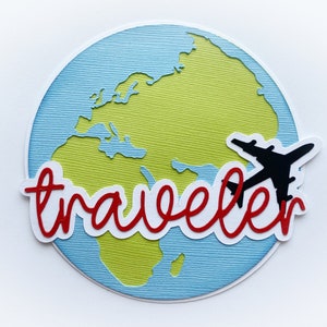 May include: A blue and green paper craft of a world map with the word "traveler" in red lettering. A black paper airplane is flying over the map.
