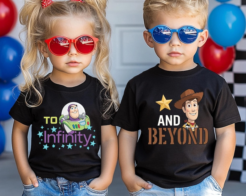 May include: Two children wearing black t-shirts with cartoon graphics. One shirt says "To Infinity" with Buzz Lightyear, the other says "And Beyond" with Woody. Both children wear sunglasses, one red, one blue.