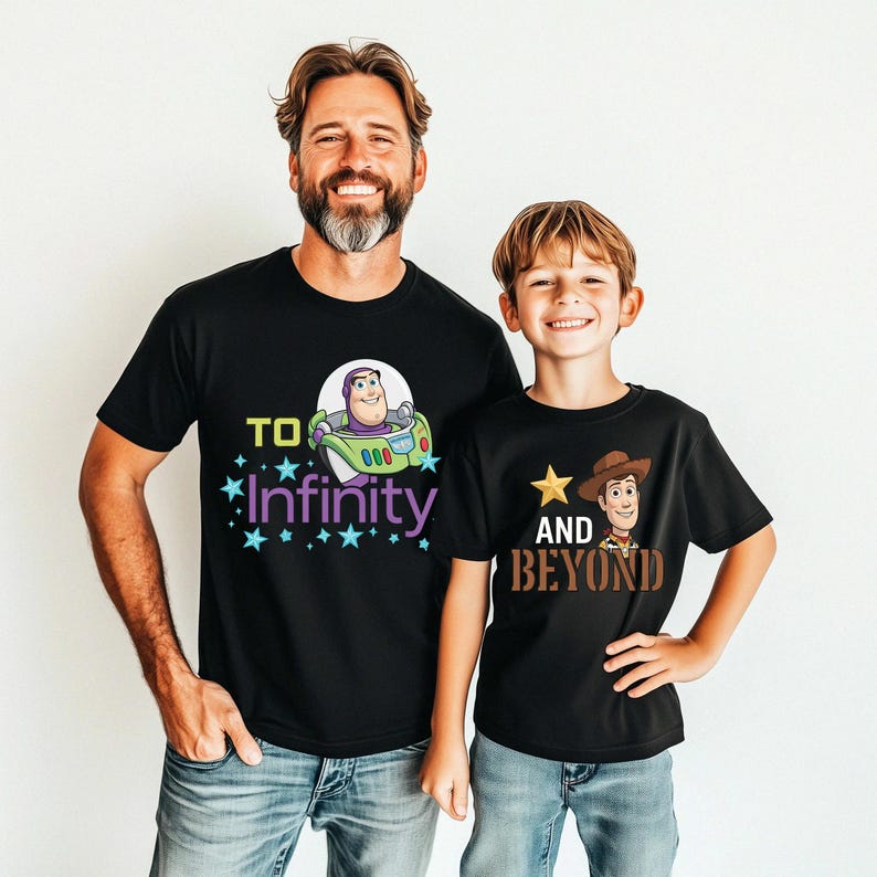 May include: Two black t-shirts with cartoon graphics. One shirt features Buzz Lightyear with the text "To Infinity" in yellow and purple. The other shirt displays Woody with the text "And Beyond" in brown.