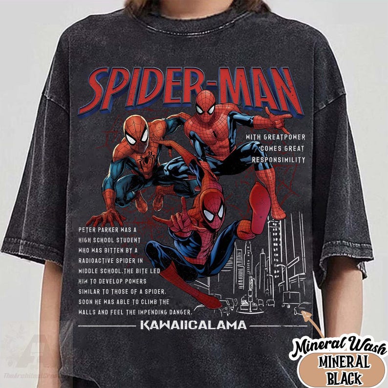 May include: Black mineral wash t-shirt featuring a graphic of Spider-Man in action poses. The design includes the text "SPIDER-MAN" in red and blue, along with a cityscape and text describing Spider-Man's origin story.