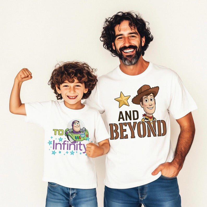 May include: Two white t-shirts with cartoon graphics. One features Buzz Lightyear with "To Infinity" text and stars. The other has Woody with "And Beyond" text and a star. Both shirts are worn by a child and an adult.